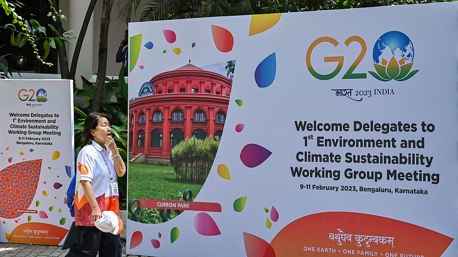An international delegate walks past a poster of the 1st Environment and Climate Sustainability working group meeting under India’s G20 Presidency in Bengaluru. Credit: AFP Photo