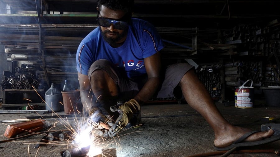 A man works at a welding shop, after the government announced a hike in power prices by 66% from today onwards, in Colombo, Sri Lanka. Credit: Reuters Photo
