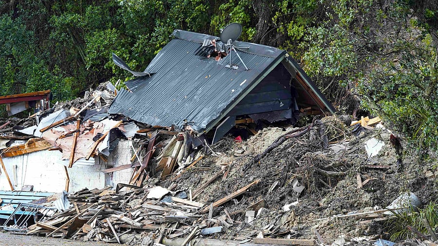 A general view of a damaged house after a storm battered Titirangi, a suburb of New Zealand's West Auckland area, on February 13, 2023. Credit: AFP Photo