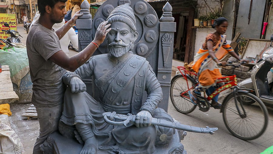 An artisan gives final touches to an idol of Chhatrapati Shivaji Maharaj ahead of Shiv Jayanti, in Nagpur, Friday, Feb. 17, 2023.  Credit: PTI Photo