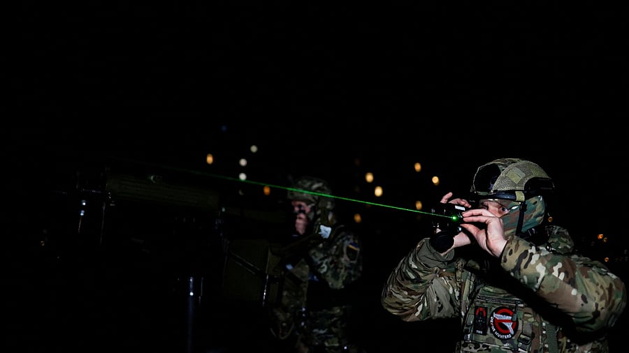 Hairdresser and Ukrainian Territorial Defence unit volunteer Oleksandr Shamshur, 41-year-old, and his mate check situation as they guard sky over capital against Russian suicide drones, amid Russia's attack on Ukraine, in Kyiv, Ukraine February 2, 2023. Credit: Reuters File Photo