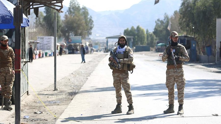 Taliban security personnel stand guard along a road after gunfire erupted between Afghanistan and Pakistan border forces at Torkham border crossing between Afghanistan and Pakistan, in Nangarhar province on Ferbruary 20, 2023. Credit: AFP Photo