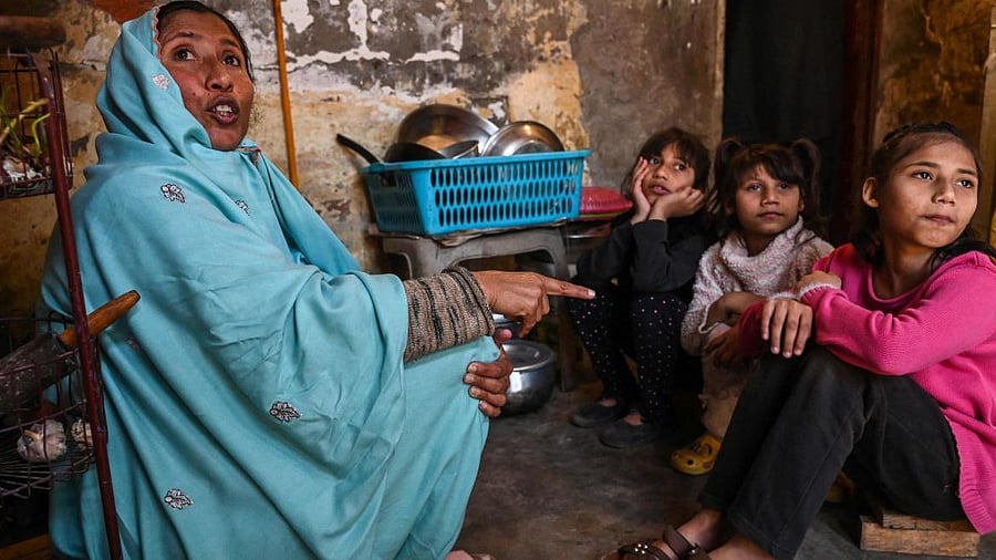 A Pakistani family sits in their house during dinner time amid the country's wrecked economy. Credit: PTI Photo