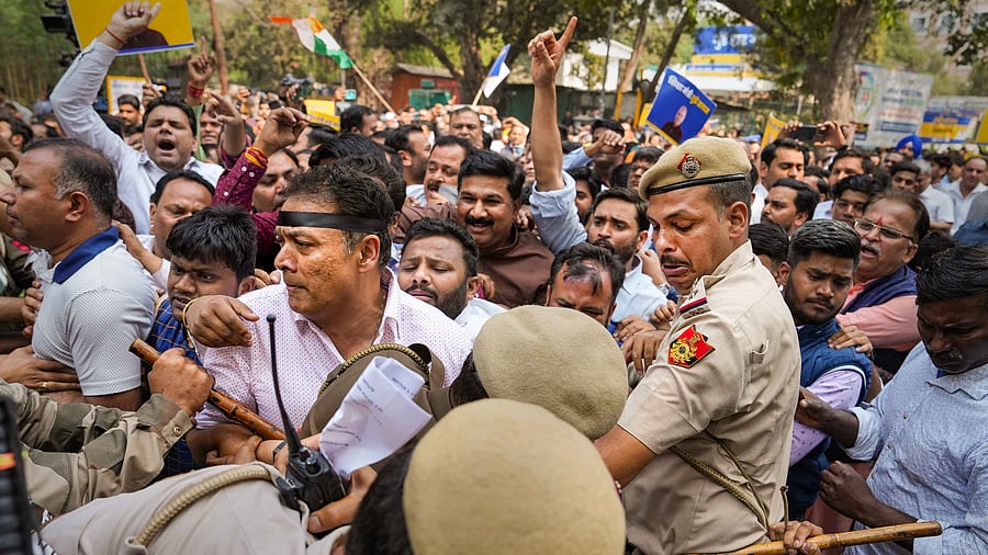 Police personnel try to stop AAP supporters protesting over Delhi Deputy Chief Minister Manish Sisodia's arrest by CBI. Credit: PTI Photo