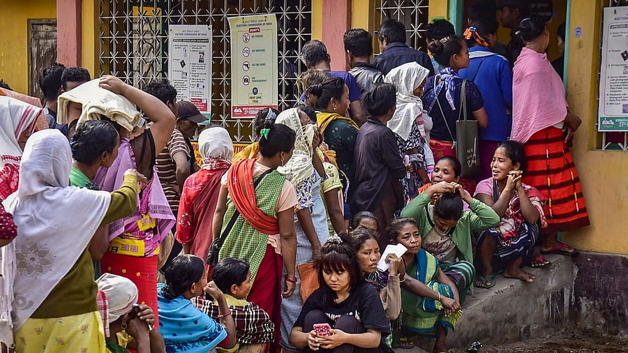 Voters wait in queues to cast their votes at a polling booth during the Meghalaya Assembly elections, in Ri Bhoi district. Credit: PTI Photo