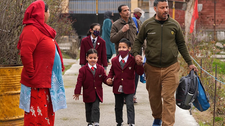 Students arrive at their school on the first day after winter break in the Valley. Credit: PTI Photo