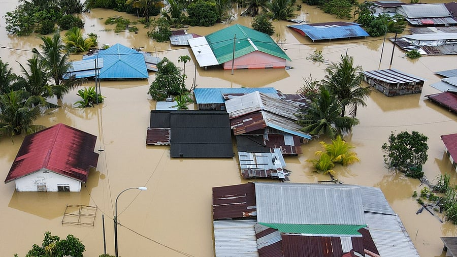An aerial view shows flooded houses in Yong Peng, Malaysia's Johor state, on March 4, 2023. Credit: AFP Photo