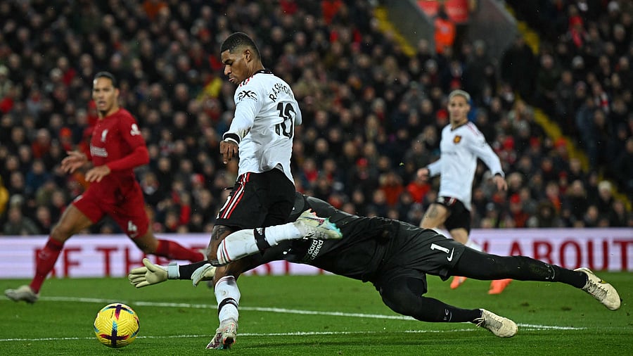 Manchester United's English striker Marcus Rashford (2L) goes around Liverpool's Brazilian goalkeeper Alisson Becker but fails to score during the English Premier League football match between Liverpool and Manchester United at Anfield in Liverpool. Credit: AFP Photo