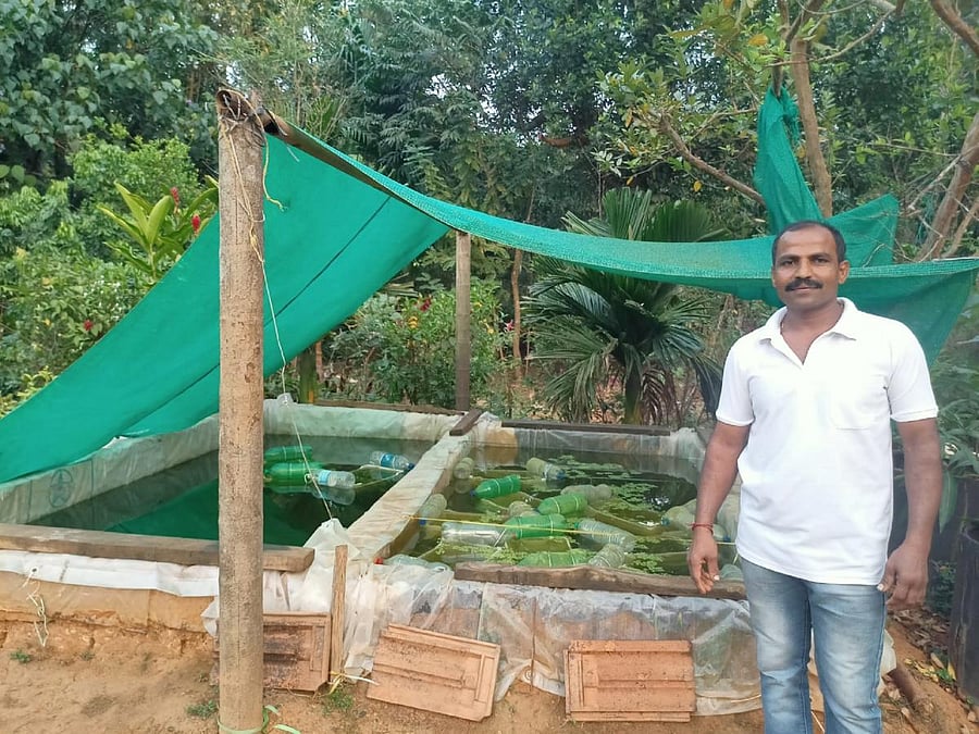 Naveen Chathubai is near the tank where freshwater mussels are being cultivated to grow pearls. Credit: DH Photo