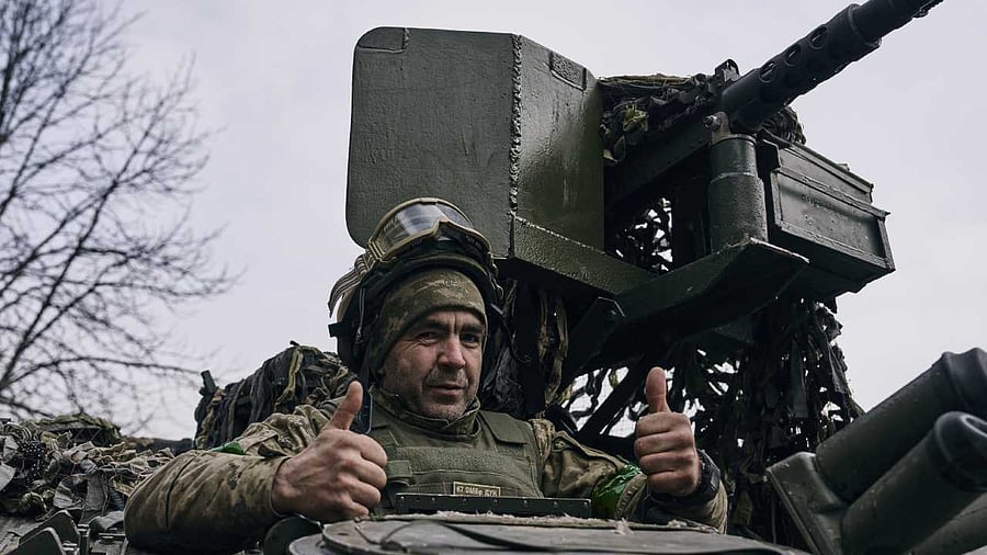 A Ukrainian soldier gives thumbs up from an APC near Bakhmut, the site of the heaviest battles. Credit: AP/PTI Photo
