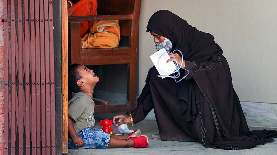 A mother pacifies her child with Acute Respiratory Infections at emergency department of the B C Roy Post Graduate Institute of Paediatric Sciences. Credit: PTI Photo