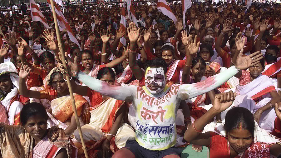 Tribals wearing traditional attire take part in a Maharally demanding separate ‘Sarna Dharm Code’ for tribals, at Morhabadi grounds in Ranchi. Credit: PTI Photo