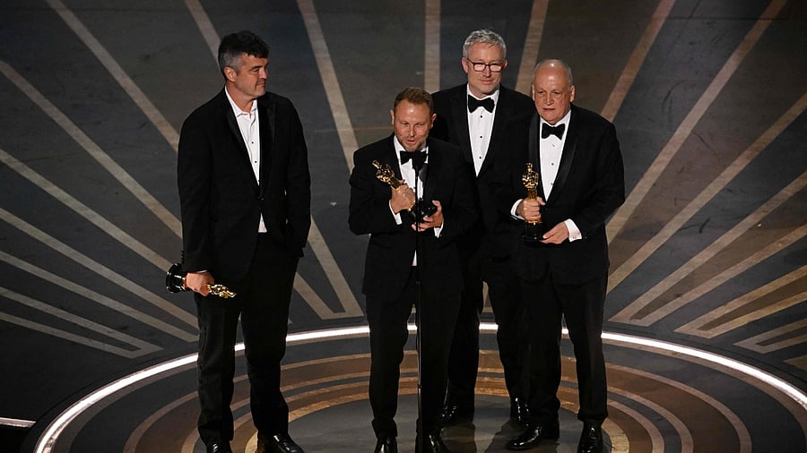 US visual effects artist Richard Baneham (C) accepts the Oscar for Best Visual Effects for 'Avatar: The Way of Water' onstage during the 95th Annual Academy Awards at the Dolby Theatre in Hollywood, California on March 12, 2023. Credit: AFP Photo