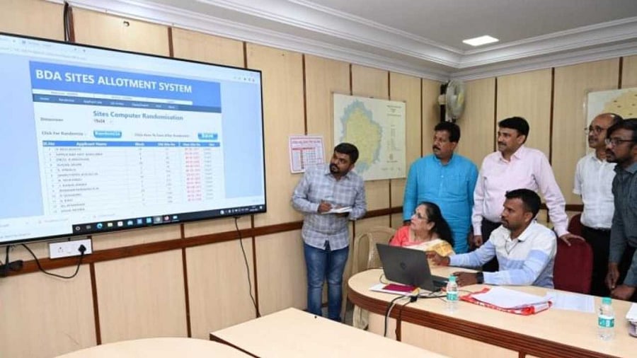 Officials oversee randomisation of site allotments at the BDA headquarters. Credit: Special Arrangement