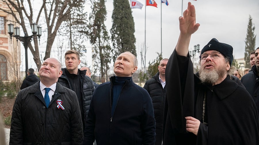Russian President Vladimir Putin (C), Governor of Sevastopol Mikhail Razvozhayev and Metropolitan Tikhon (Shevkunov), chairman of the Patriarchal Council for Culture, visit the state museum-preserve 'Tauric Chersonese' in Sevastopol, Crimea March 18, 2023. Credit: Reuters/Sputnik/Russian Presidential Press Office/Kremlin