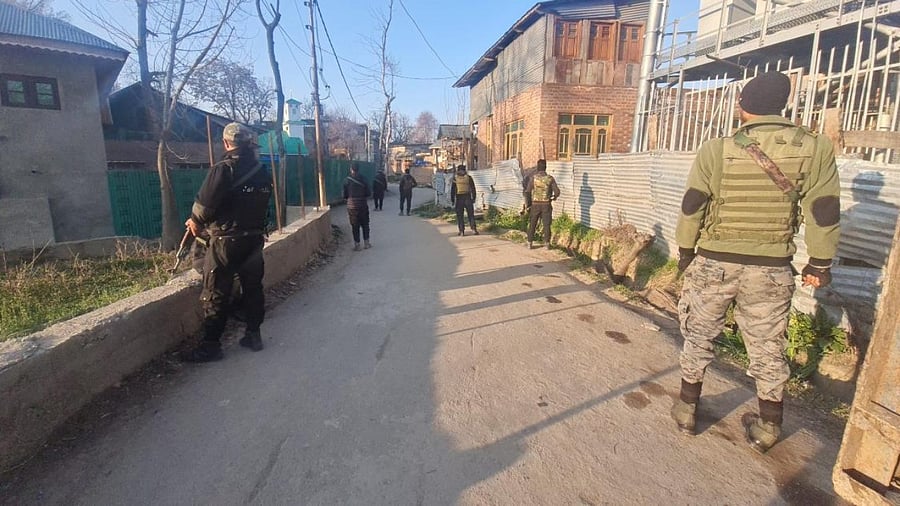 Security personnel stand guard during raids conducted by National Investigation Agency (NIA) in connection with terror-funding cases, in Jammu & Kashmir. Credit: PTI File Photo