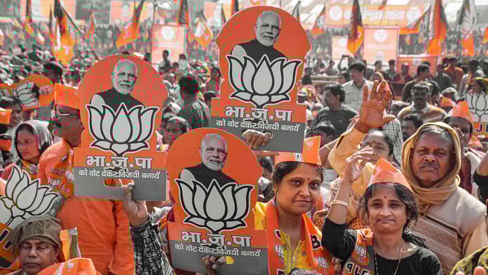 BJP supporters during the launch of the party's 'Jan Vishwas Yatra' by Amit Shah at Dhamanagar in poll-bound Tripura. Credit: PTI Photo