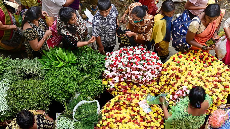 Despite a sharp price hike, people thronged the flower stalls at KR Market on Tuesday. Credit: DH Photo