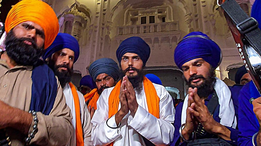 'Waris Punjab De' founder Amritpal Singh (C). Credit: PTI Photo