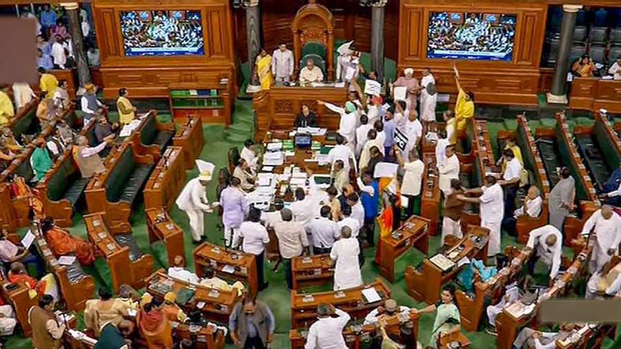 Opposition members protest in the well of the Lok Sabha during Budget Session of Parliament, in New Delhi, Thursday, March 23, 2023. Credit: PTI Photo
