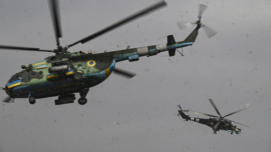 An Mi-24 (R) and an Mi-8 (L) helicopters take off for a mission against Russian targets in Ukraine. Credit: AFP Photo