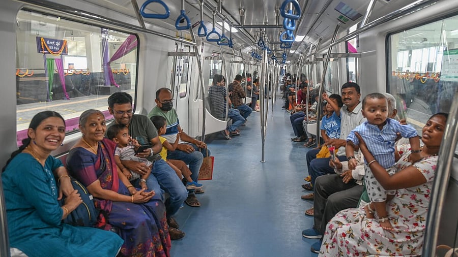 Passengers are all smiles as they ride on the Whitefield-KR Pura metro train for the first time, on Sunday. DH Photo/ K Dinesh