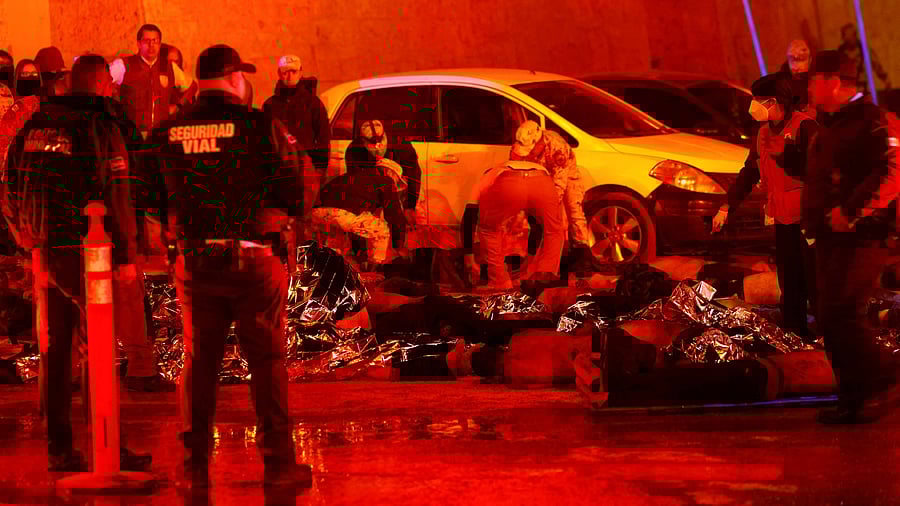 Mexican authorities and firefighters remove injured migrants, mostly Venezuelans, from inside the National Migration Institute (INM) building during a fire. Credit: Reuters Photo