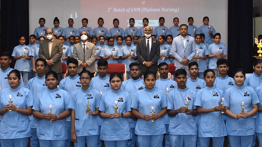 Students of third batch of General Nursing Midwifery from KLES Centenary Institute of Nursing Sciences, Yellur Road in Belagavi during the lamp lighting and oath taking ceremony held recently. Credit: DH Photo