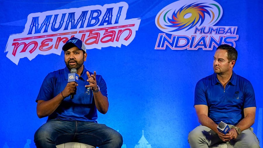 Mumbai Indians' cricket team captain Rohit Sharma speaks as coach Mark Boucher watches during a news conference in Mumbai. Credit: AFP Photo