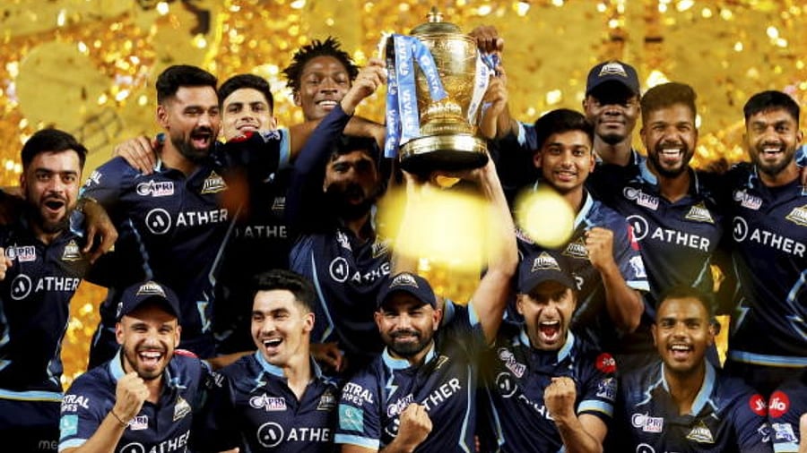Gujarat Titans players with the IPL trophy after winning the final T20 cricket match of the Indian Premier League 2022. Credit: PTI Photo