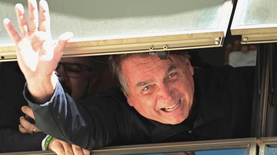 Brazil's former President Jair Bolsonaro waves at Brasilia International Airport as he returns from self imposed exile in Florida. Credit: Reuters Photo