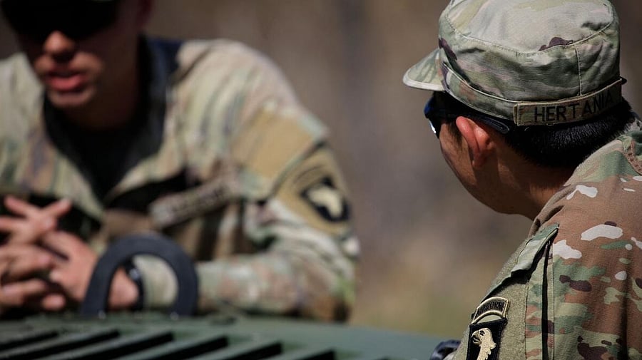 U.S. Soldiers from the U.S. Army 101st Airborne Division stand guard at a checkpoint near the site where two UH-60 Blackhawk helicopters crashed on March 30. Credit: AFP Photo