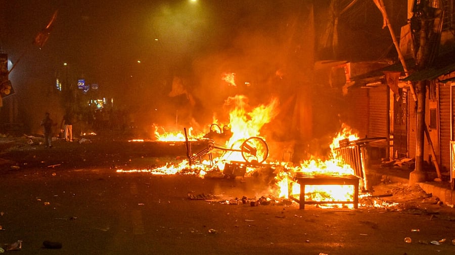 Vehicles set on fire by miscreants during clashes between two groups, at Kajipara in Howrah district. Credit: PTI Photo