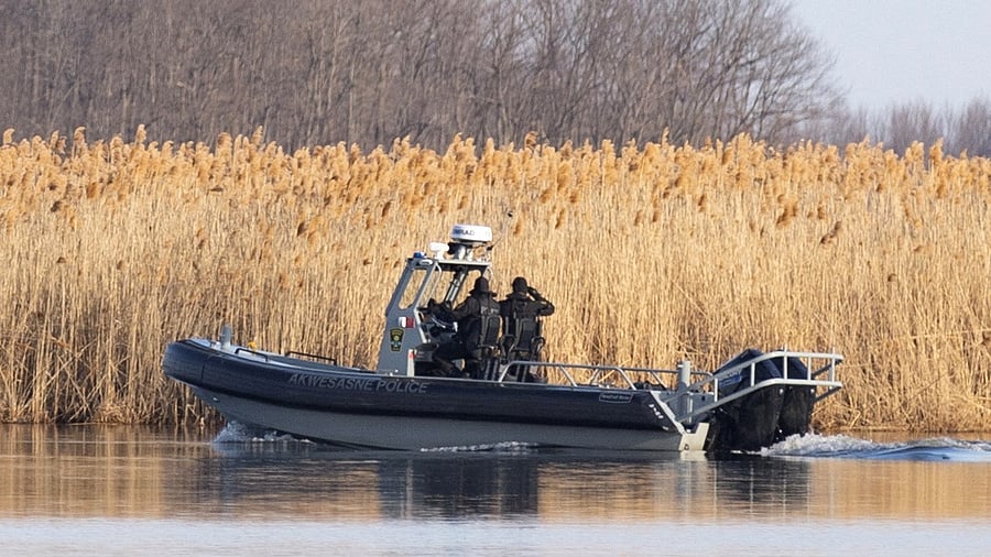 Police search the marshland where bodies were found in Akwesasne, Quebec, Canada March 31, 2023. Credit: Reuters Photo