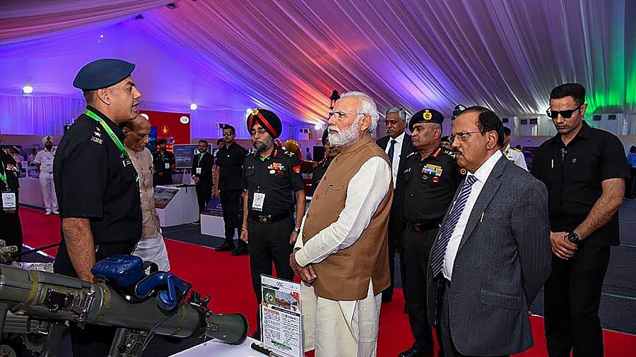 Prime Minister Narendra Modi during an exhibition at the Combined Commanders' Conference-2023 at Kushabhau Thackeray International Convention Center, in Bhopal, Saturday, April 1, 2023. NSA Ajit Doval is also seen. Credit: PTI Photo