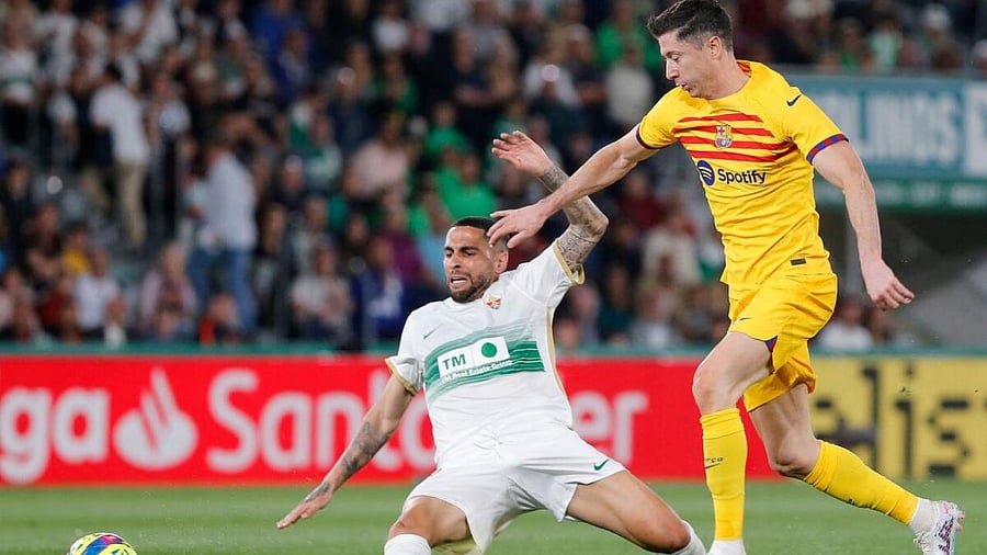 Elche's Spanish midfielder Omar Mascarell (L) vies with Barcelona's Polish forward Robert Lewandowski during the Spanish league football match between Elche CF and FC Barcelona at the Martinez Valero stadium. Credit: AFP Photo