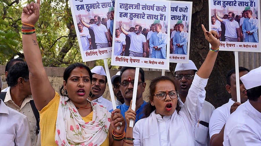 Congress workers raise slogans outside Surat District Court, on Monday, April 3, 2023. Credit: PTI File Photo