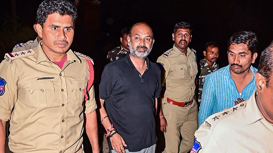Telangana BJP President and MP Bandi Sanjay Kumar being detained by the police from his residence after midnight in Karimnagar. Credit: PTI Photo
