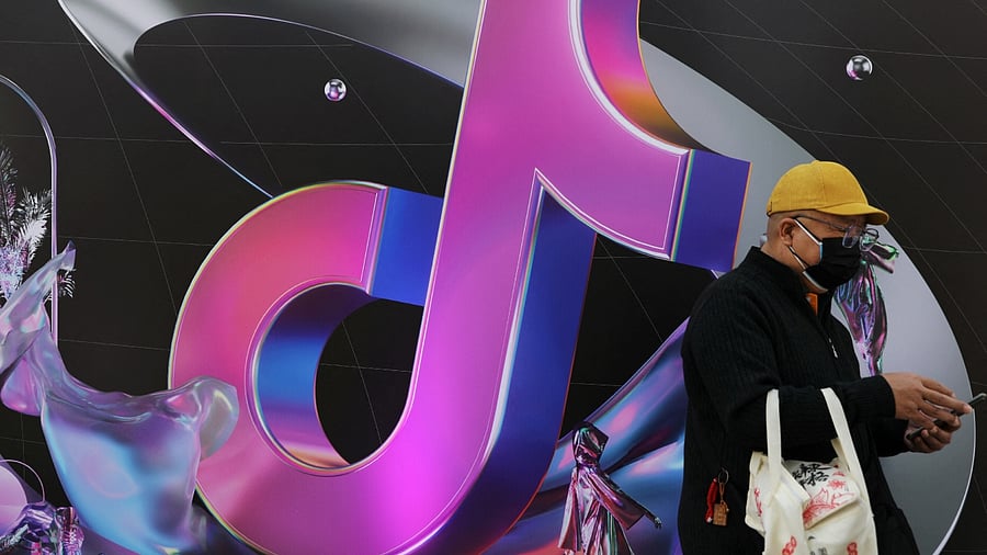 A man stands near a sign of ByteDance app Douyin during China Fashion Week, in Beijing, China March 31, 2021. Credit: Reuters File Photo