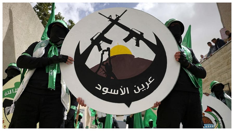 Student supporters of the Islamist Movement Hamas carry a logo of the Lion's Den armed group (Areen Al-Asood) during a university election campaign rally last month. Credit: AFP File Photo