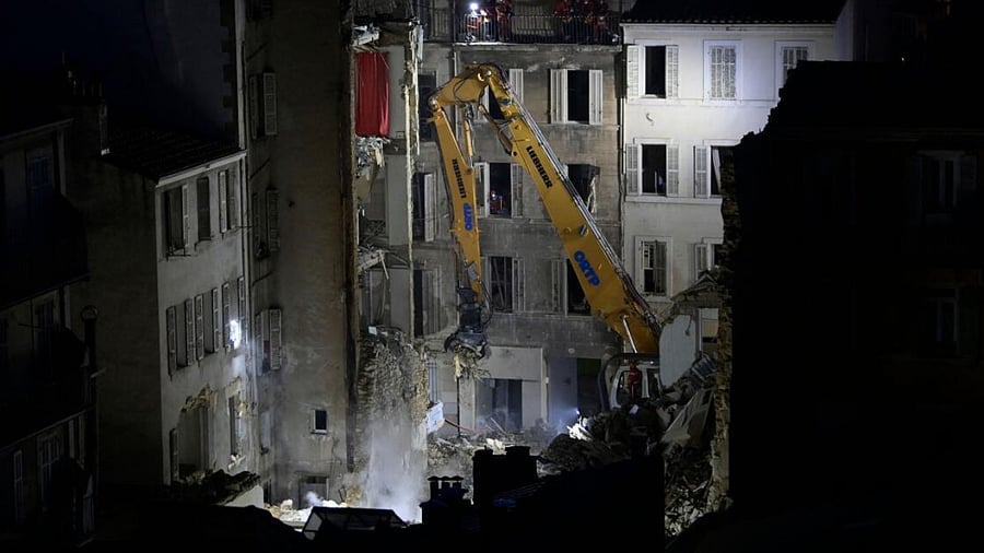 An excavator moves rubble at 'rue Tivoli' after a building collapsed in the same street, in Marseille. credit: AFP Photo