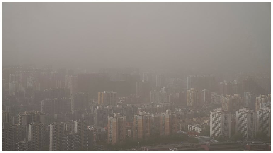 Buildings are shrouded in dust and sand in Beijing, Tuesday, April 11, 2023. Credit: AP Photo