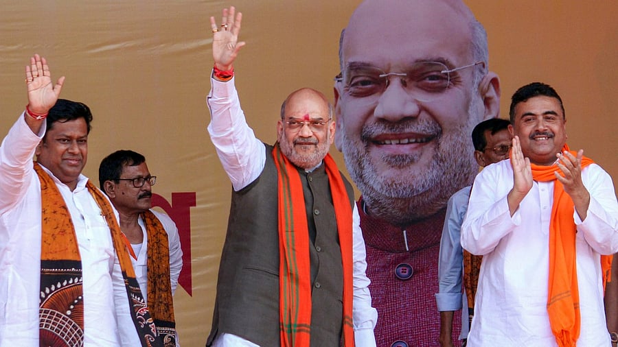 Union Home Minister Amit Shah with BJP WB President Sukanta Majumdar and party leader Suvendu Adhikari during a public meeting, in Birbhum district. Credit: PTI Photo