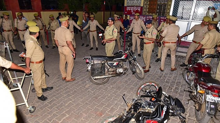 Police personnel at the site where Gangster-turned-politician Atiq Ahmed and his brother Ashraf Ahmed were shot dead. Credit: PTI Photo 
