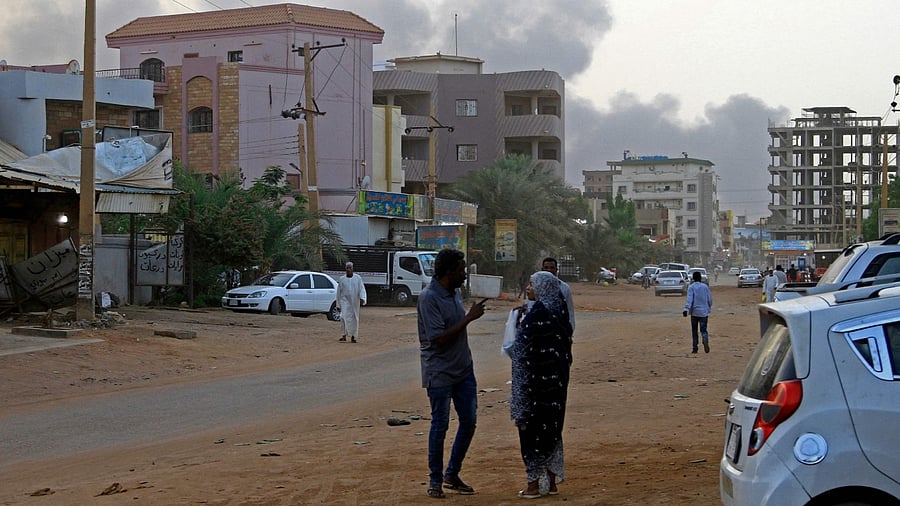 Smoke billows above residential buildings in Khartoum. Credit: AFP Photo