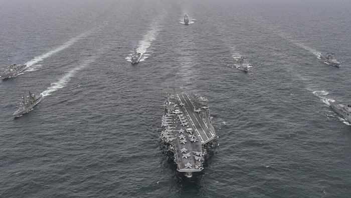 South Korean Navy's destroyer Yulgok Yi I, front row right, US Navy's aircraft carrier USS Nimitz, center, Japan Maritime Self-Defense Force's Umigiri, front row left, sail in formation during a joint naval exercise. Credit: AP File Photo