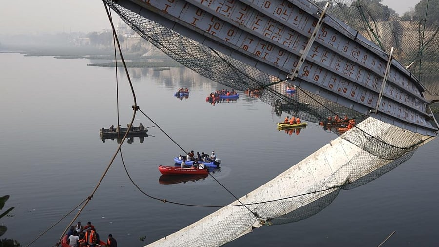 Rescue operation underway after the collapse of a suspension bridge over the Machchhu river, in Morbi. credit: PTI File Photo