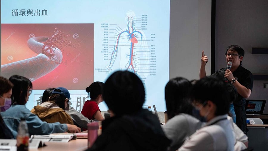 Students listen to an instructor teaching first aid during a civil defence course at Kuma Academy in Taipei. Credit: AFP Photo
