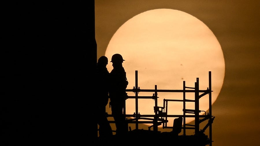 Workers prepare the SpaceX Starship as the sun sets behind them ahead of the launch from the SpaceX Starbase in Boca Chica, Texas on April 18. Credit: AFP Photo