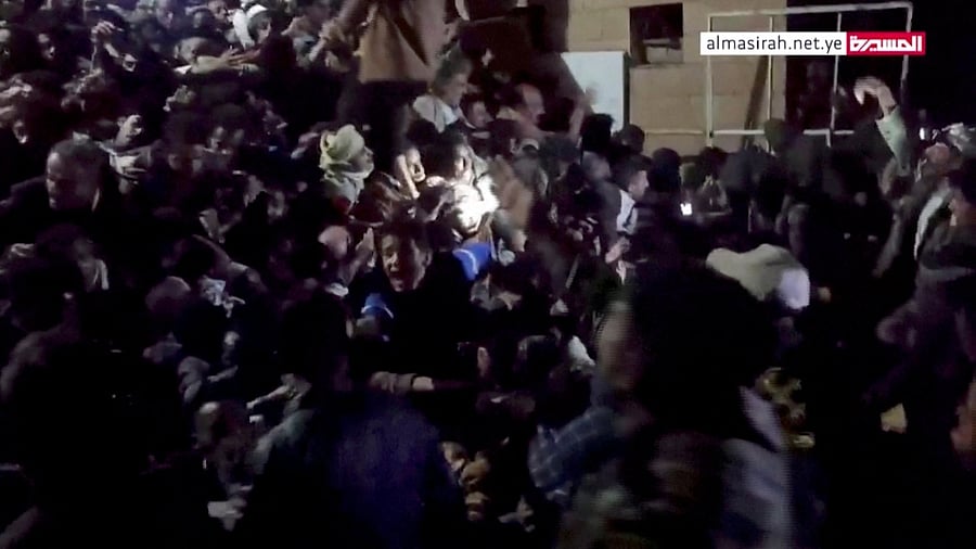 People trapped in the crowd attempt to free themselves during a stampede in Sanaa, Yemen, April 19, 2023, in this still image taken from video. Credit: Al Masirah TV/via Reuters.